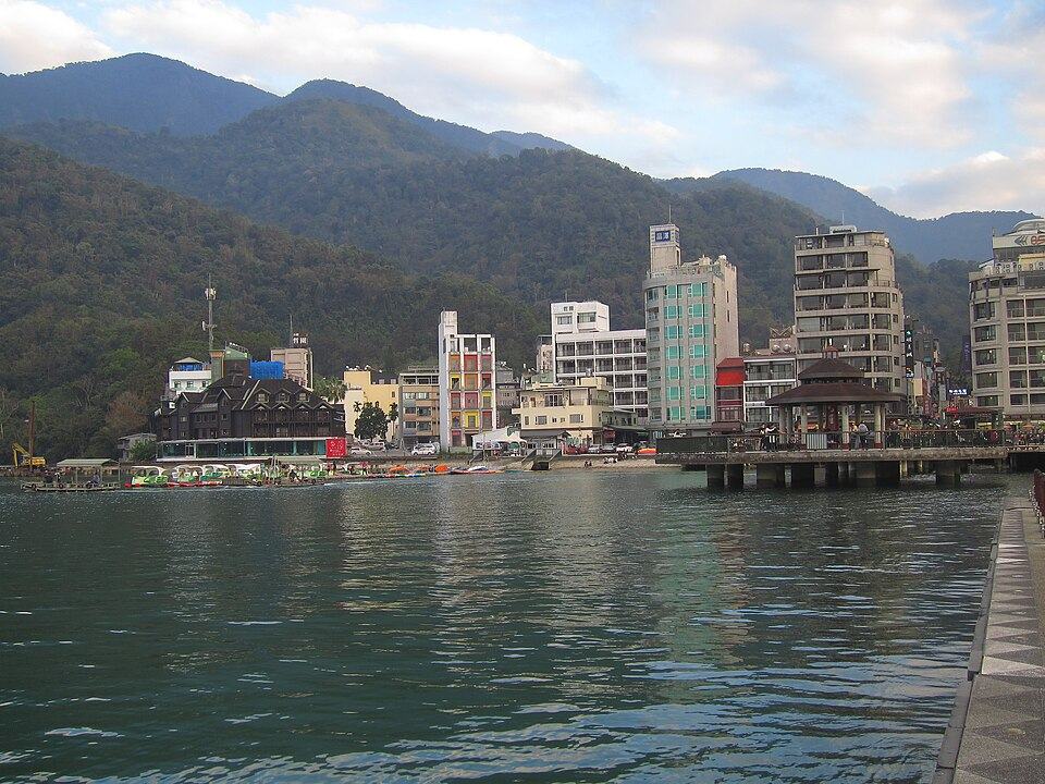 Sun Moon Lake with forested mountains behind the town
