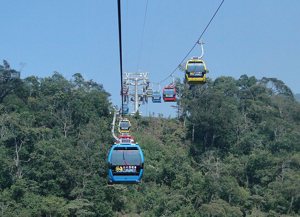 Ropeway gondolas over forest